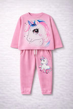 Pink children's pajama set with unicorn design on a light gray background