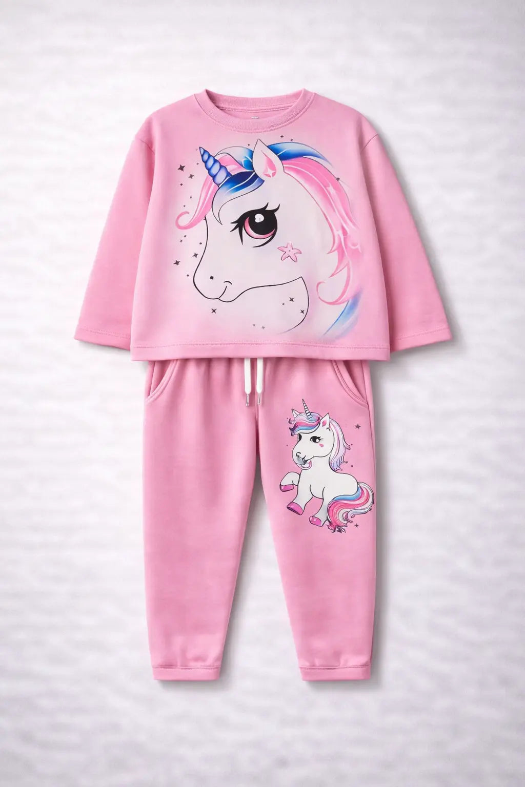 Pink children's pajama set with unicorn design on a light gray background